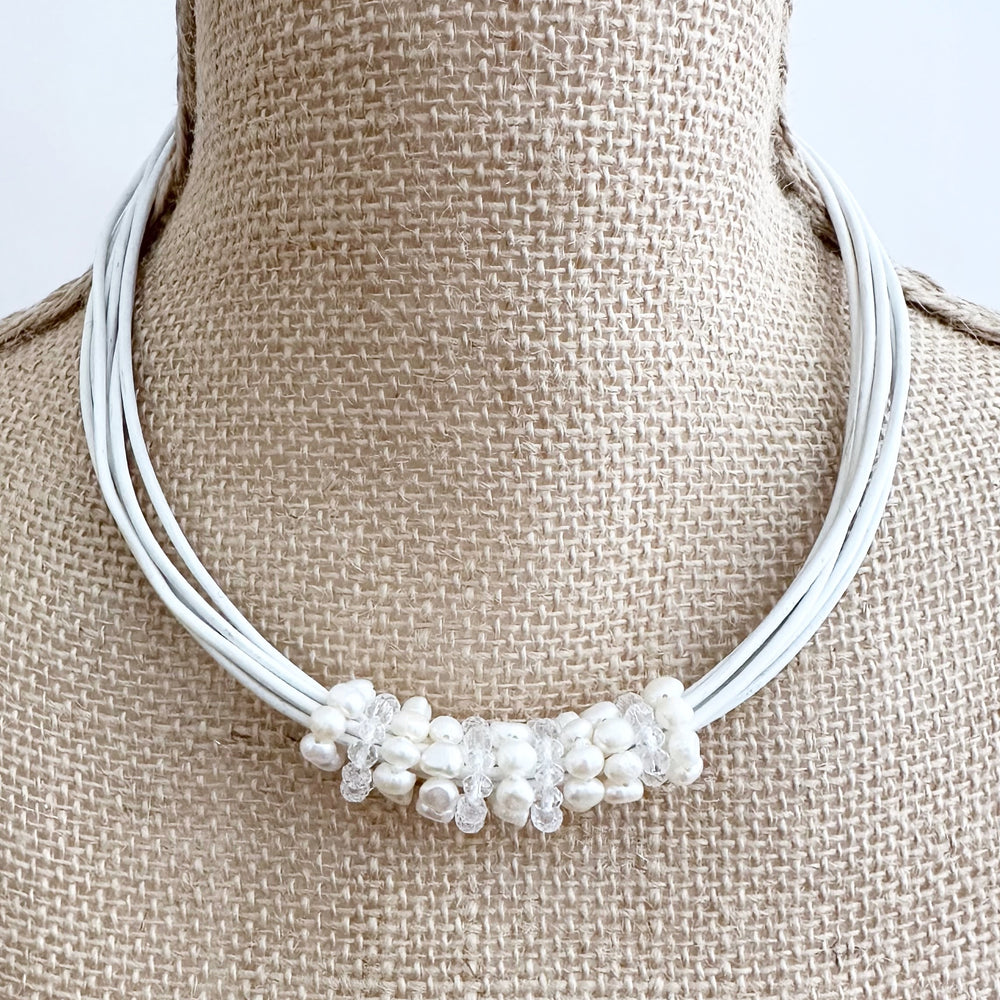 
                      
                        Pretty Baroque White Freshwater Pearl and Crystal Rings Float on Strands of White 18” Long Leather in this Necklace, Finished by a Strong Secure Magnetic Clasp for Easy Wear.
                      
                    