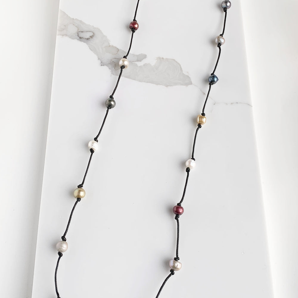 Lustrous Multi-Colored Freshwater Pearls Knotted on Black Cotton in this 21” Necklace.