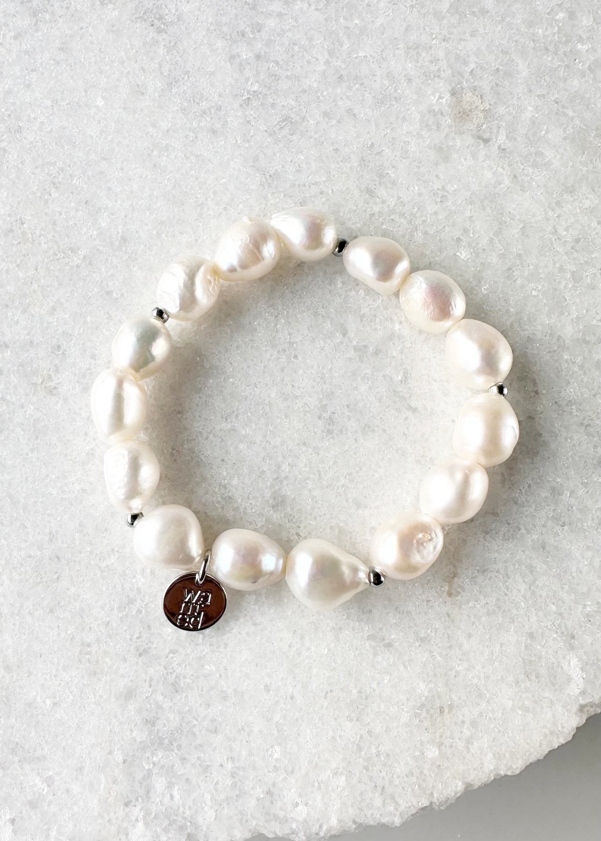 Designed in Canada, this sample 7” Stretch Bracelet has Beautiful Oval-shape Baroque Pearls with small Silver-plated Bead accents.