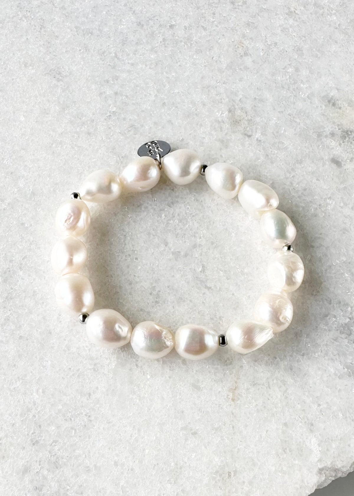 Designed in Canada, this sample 7” Stretch Bracelet has Beautiful Oval-shape Baroque Pearls with small Silver-plated Bead accents.