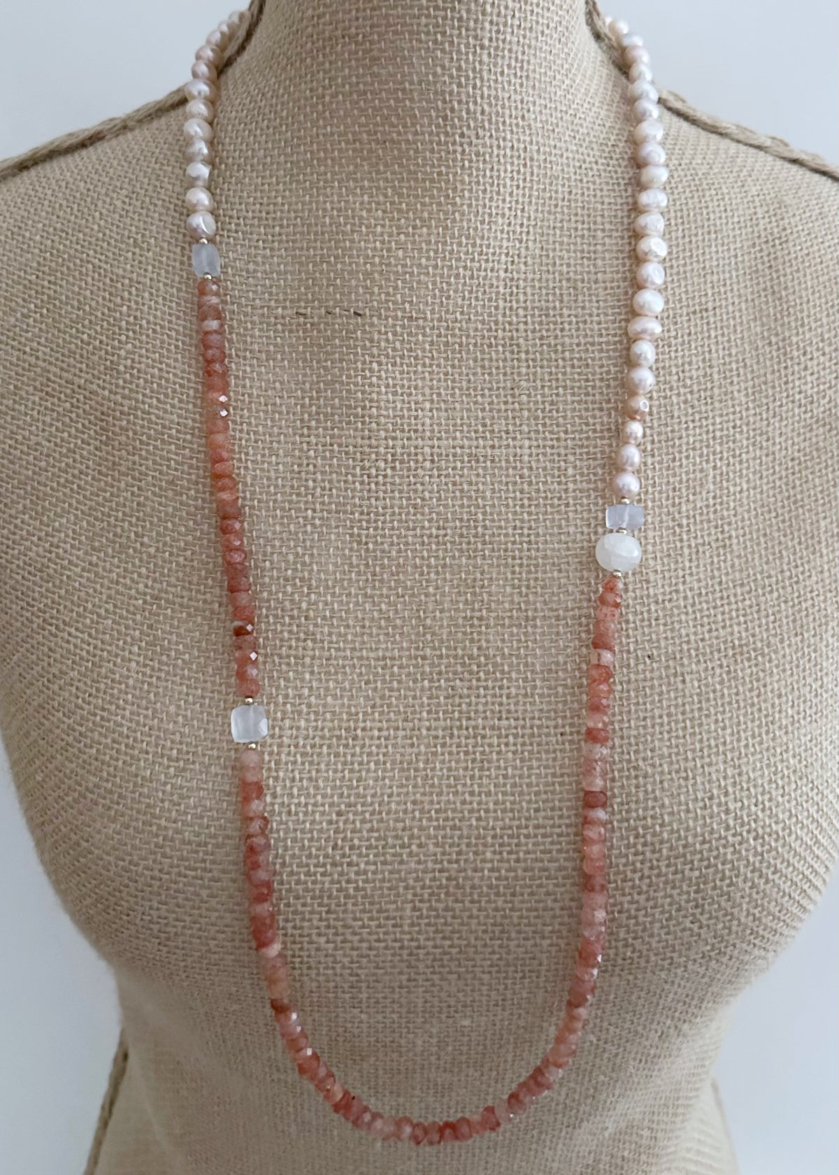 Designed and made in Canada, this beautiful one-of-a-kind 34” Necklace has a mix of sparkly Faceted Sunstone, light Blue Chalcedony and pink Baroque Pearls accented with tiny Gold beads and is finished with a Gold-plated Clasp. Wear it long or doubled.