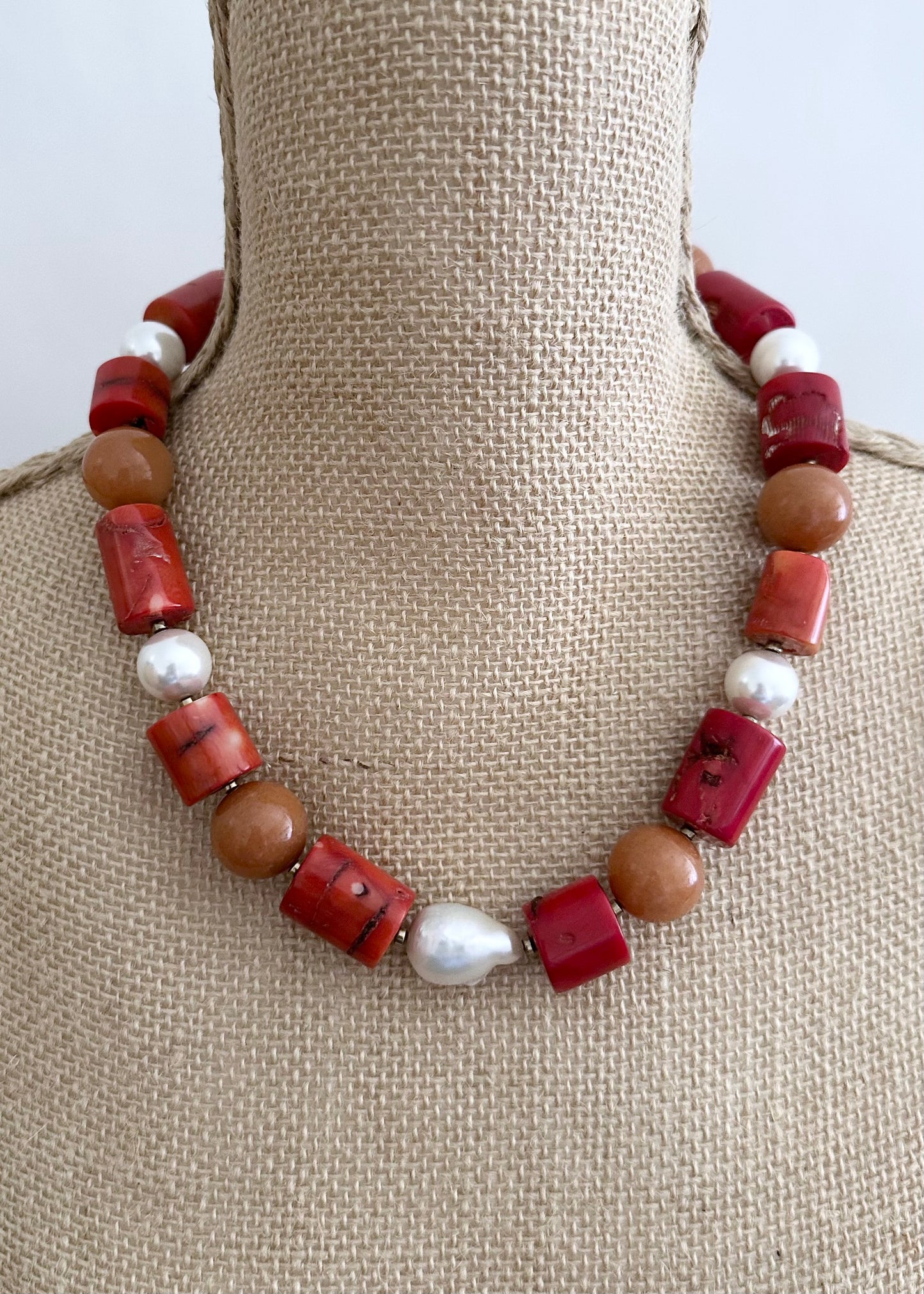 This Unique 21” Necklace Features Vibrant Red Sea Bamboo, Orange Aventurine, Shell Pearls and a Beautiful Baroque Freshwater Pearl Finished with a Strong, Secure Magnetic Clasp for Easy Wear.