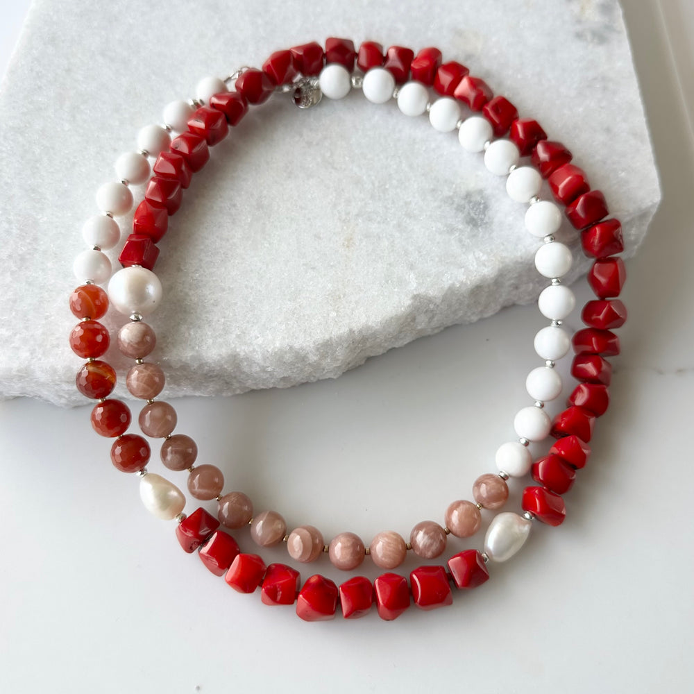 This 38” Long and Beautiful Necklace Boasts a Rich Blend of Colours including Vibrant Red Sea Bamboo, Soft Peach Moonstone, Faceted Carnelian, Crisp White Agate and Elegant White Freshwater Pearls.  The Necklace is finished with Gold and Silver Beads and a Sterling Silver Lobster Claw Clasp and can be Worn Long or Doubled Up.
