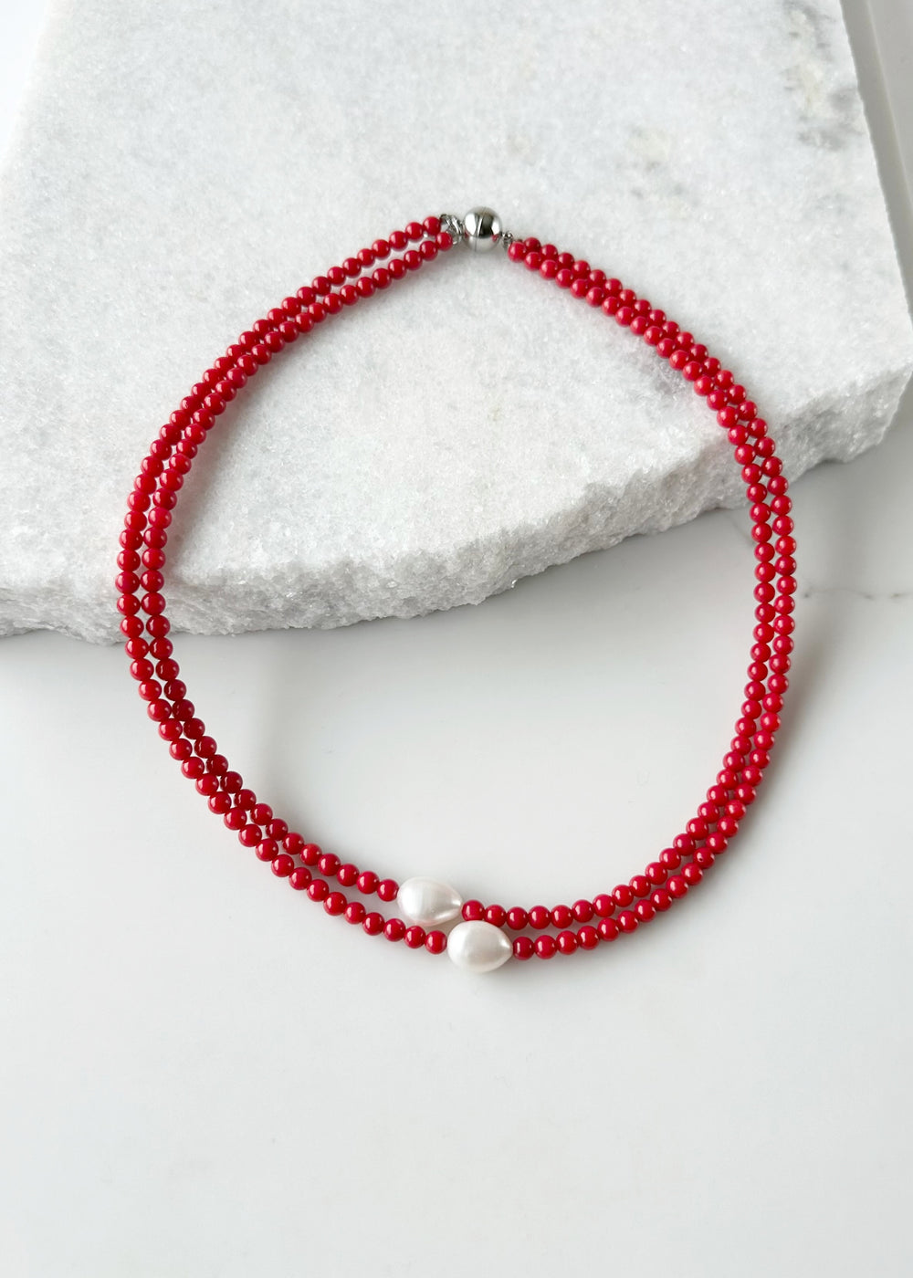 Two Lustrous White Baroque Freshwater Pearls are Highlighted and Offset on an 18” Necklace of Two Strands with 4mm Red (Canada Edition) Semi-Precious Stones Finished with a Strong Secure Magnetic Clasp for Easy Wear.