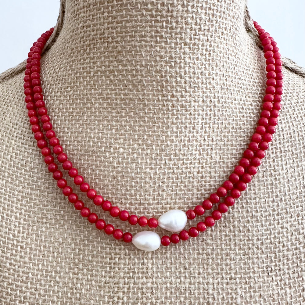
                      
                        Two Lustrous White Baroque Freshwater Pearls are Highlighted and Offset on an 18” Necklace of Two Strands with 4mm Red (Canada Edition) Semi-Precious Stones Finished with a Strong Secure Magnetic Clasp for Easy Wear.
                      
                    