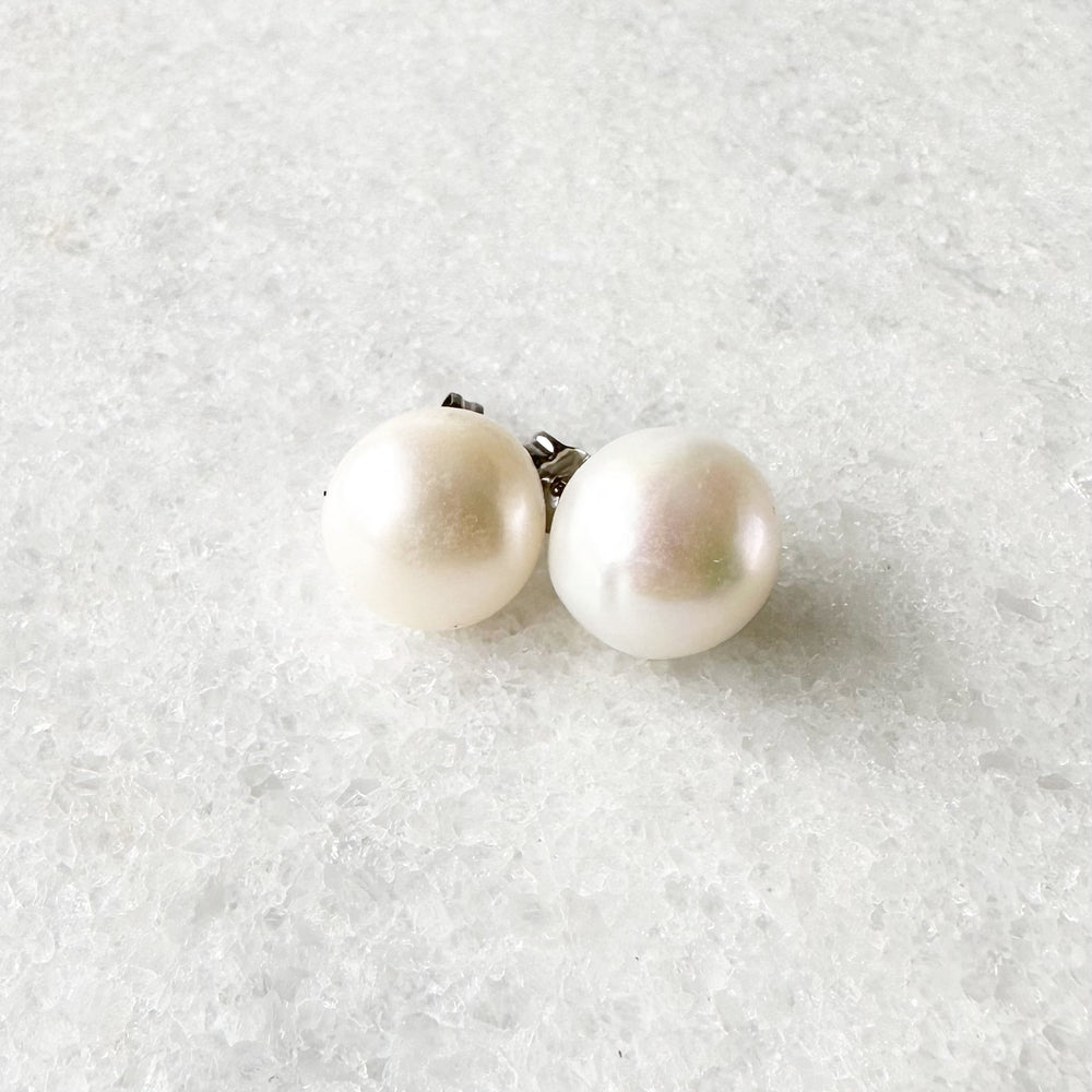 
                      
                        These Pretty White 10-11mm Freshwater Pearl Stud Earrings are on Sterling Silver Post and Butterfly.  A Fan Favorite!
                      
                    