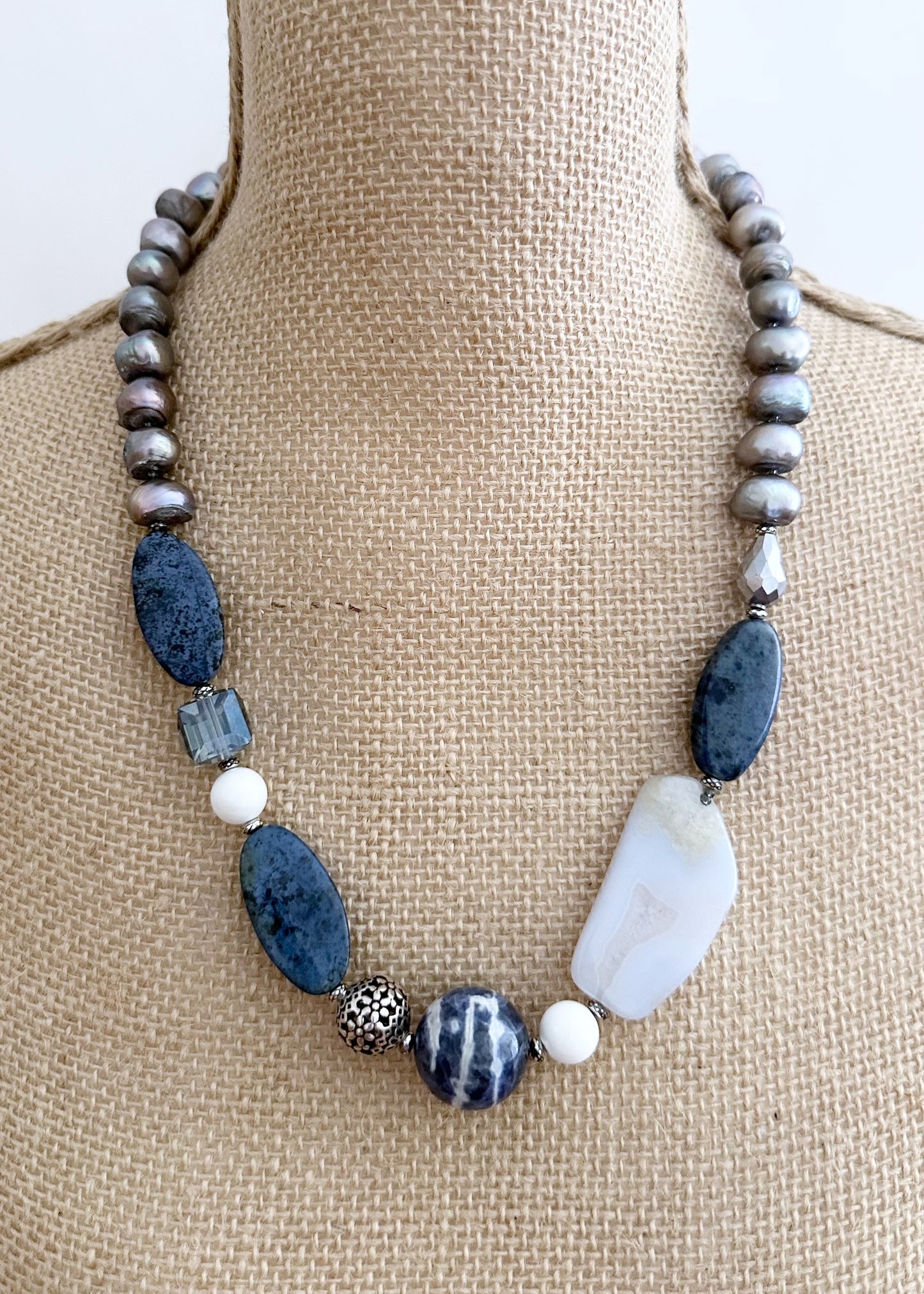 This Unique 23” Necklace Combines a Captivating Blend of Sodalite, Blue Lace Agate, Dumortierite, Silver, Crystal, Silver Freshwater Pearls and Finished with a Magnetic Clasp, Creating a Truly Distinctive Piece. Designed and made in Canada