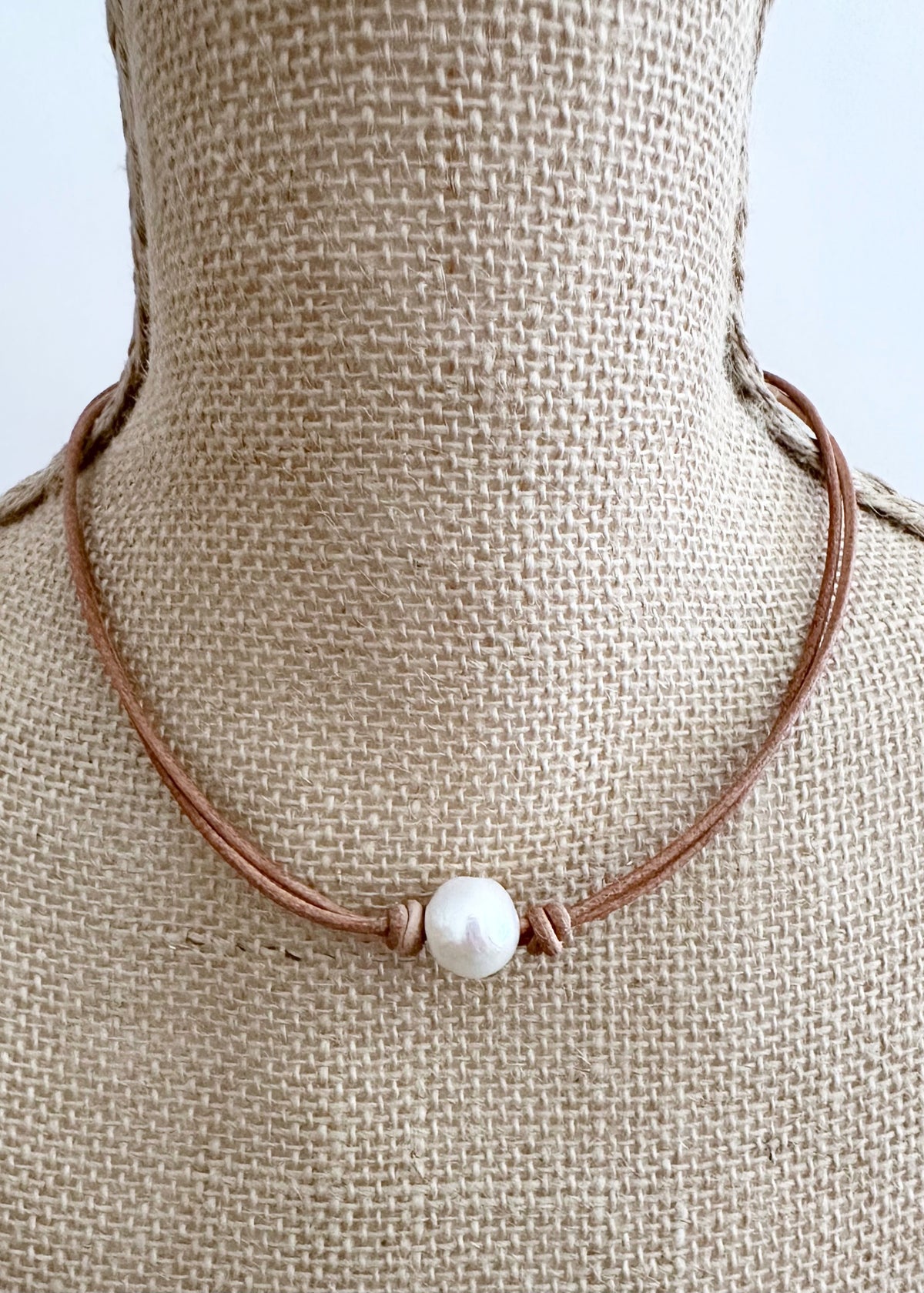 Designed in Canada, the 17” Tegan Necklace features One Large, Lustrous, Freshwater Pearl suspended on Two Strands of Leather and finished with a Magnetic Clasp for Easy Wear. Tegan is Pretty and Understated for an Elegant Style.