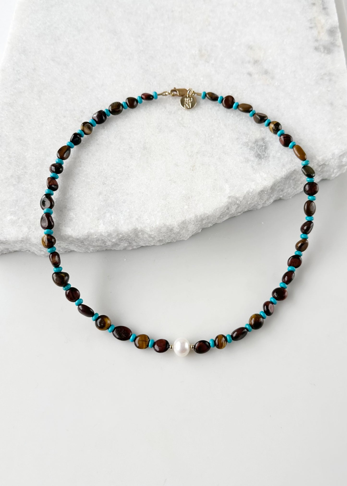 Designed and Made in Canada, this One-Of-A-Kind 18” Necklace features a Beautiful White Pearl Surrounded by Blue Tibetan Turquoise, Gold and Red Tiger's Eye, and Tiny Gold Accents.  This Piece is Finished with a Gold-filled Lobster Claw Clasp.