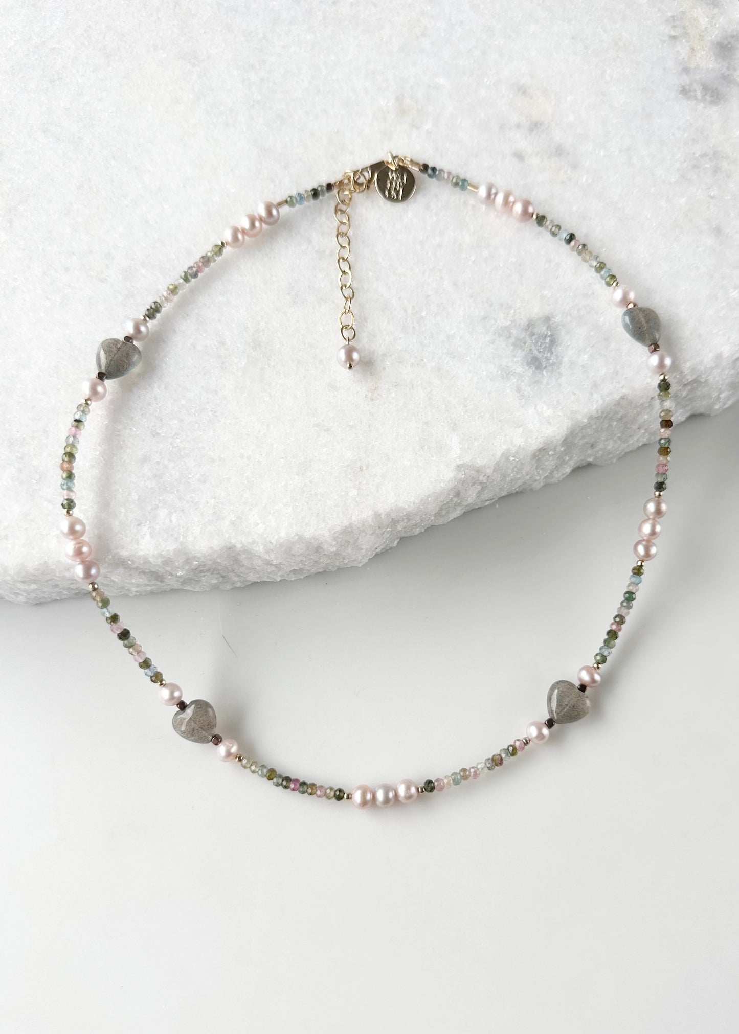 Designed and made in Canada, this Delicate, One-Of-A-Kind 17.5” Necklace Features Faceted 3mm Tourmaline, Charming Labradorite 10mm Hearts and Pretty Pink 5mm Pearls accented with Gold-Filled Beads and Completed with a Gold-Filled Lobster Claw Clasp.