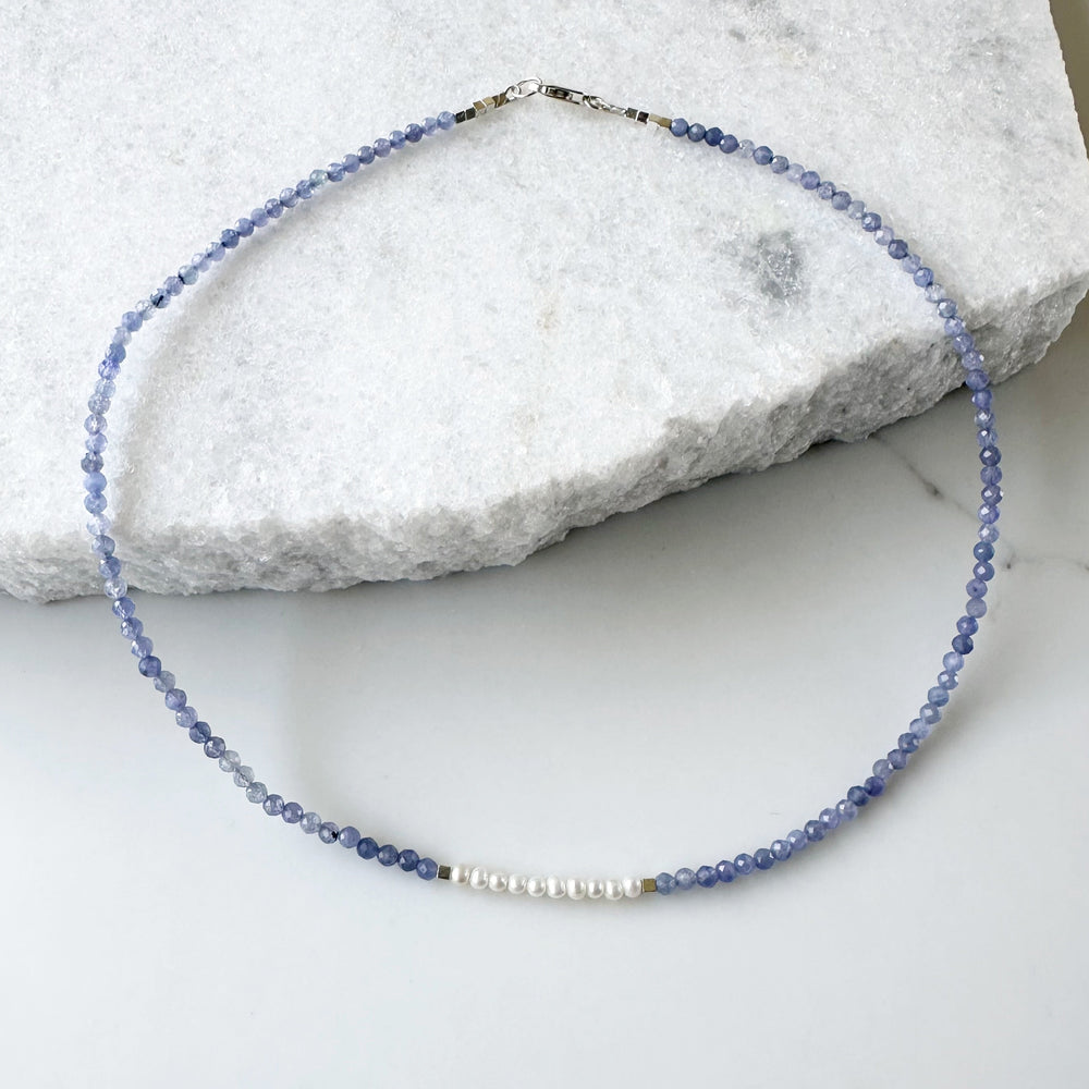 Designed and made in Canada, this Charming, Limited Edition, 17.5” Necklace has Beautiful Blue Tanzanite and Tiny Lustrous White Pearls for a Delicate and pretty look.  It is finished with Hematite and a Sterling Silver Lobster Claw Clasp.