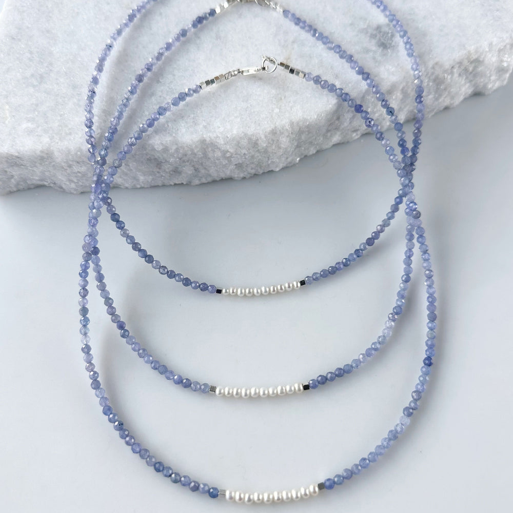 
                      
                        Designed and made in Canada, this Charming, Limited Edition, 17.5” Necklace has Beautiful Blue Tanzanite and Tiny Lustrous White Pearls for a Delicate and pretty look.  It is finished with Hematite and a Sterling Silver Lobster Claw Clasp.
                      
                    