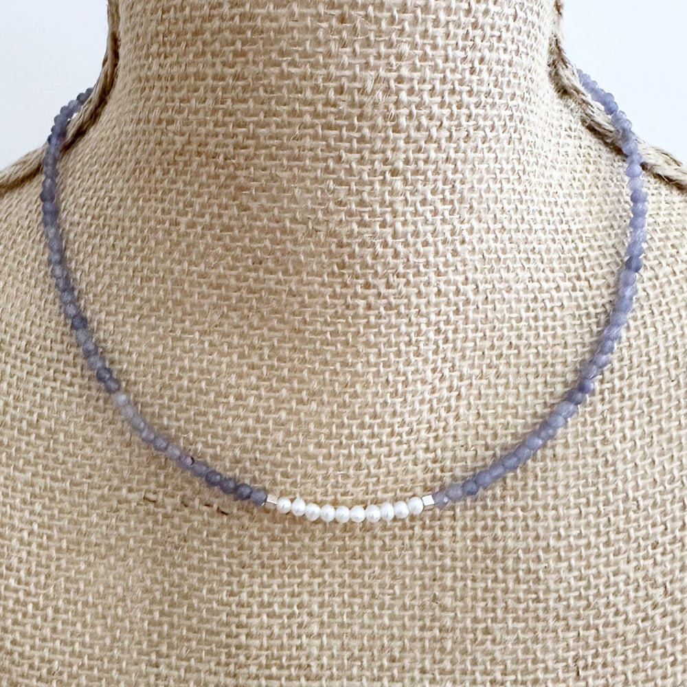 Designed and made in Canada, this Charming, Limited Edition, 17.5” Necklace has Beautiful Blue Tanzanite and Tiny Lustrous White Pearls for a Delicate and pretty look.  It is finished with Hematite and a Sterling Silver Lobster Claw Clasp.
