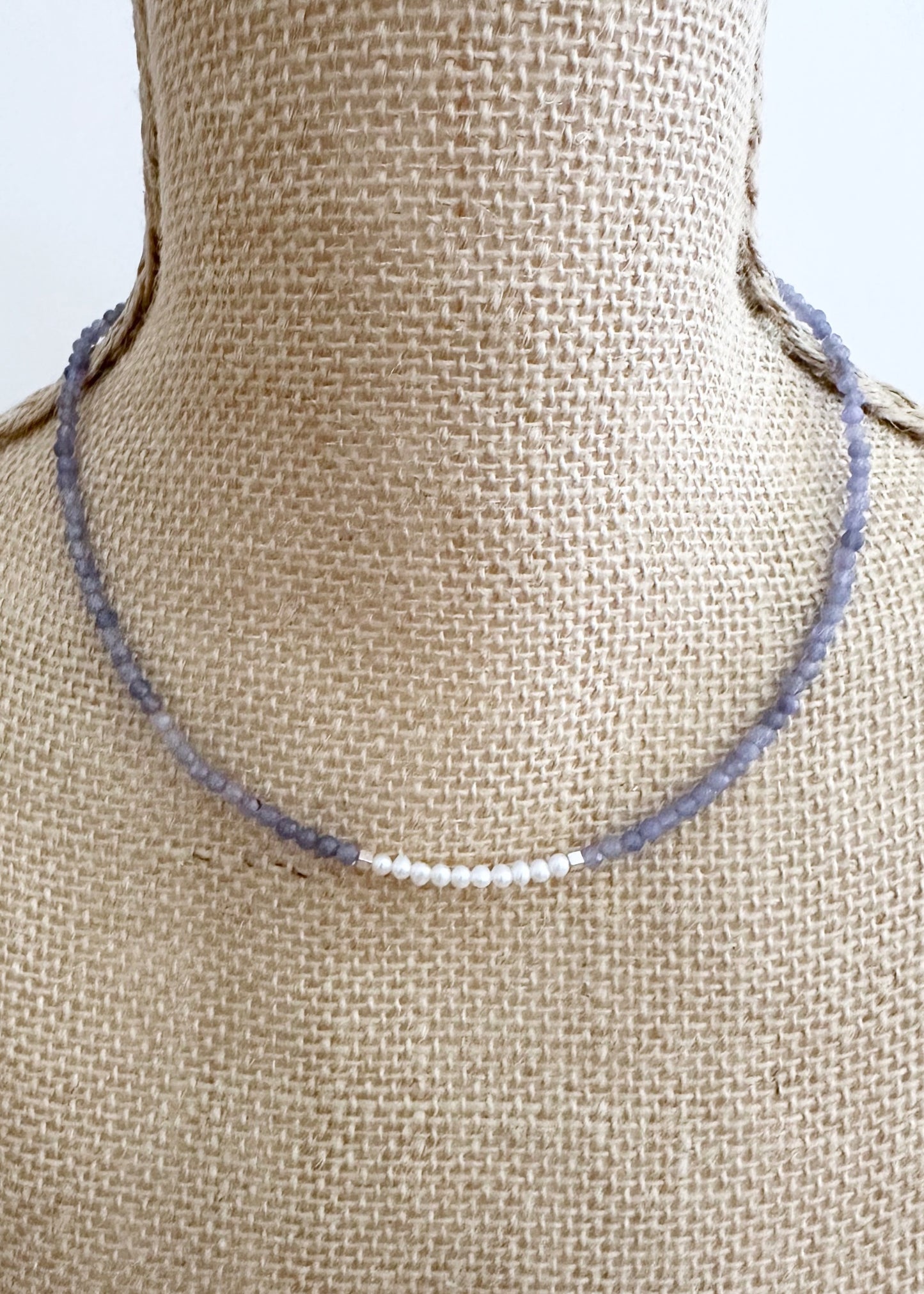 Designed and made in Canada, this Charming, Limited Edition, 17.5” Necklace has Beautiful Blue Tanzanite and Tiny Lustrous White Pearls for a Delicate and pretty look.  It is finished with Hematite and a Sterling Silver Lobster Claw Clasp.