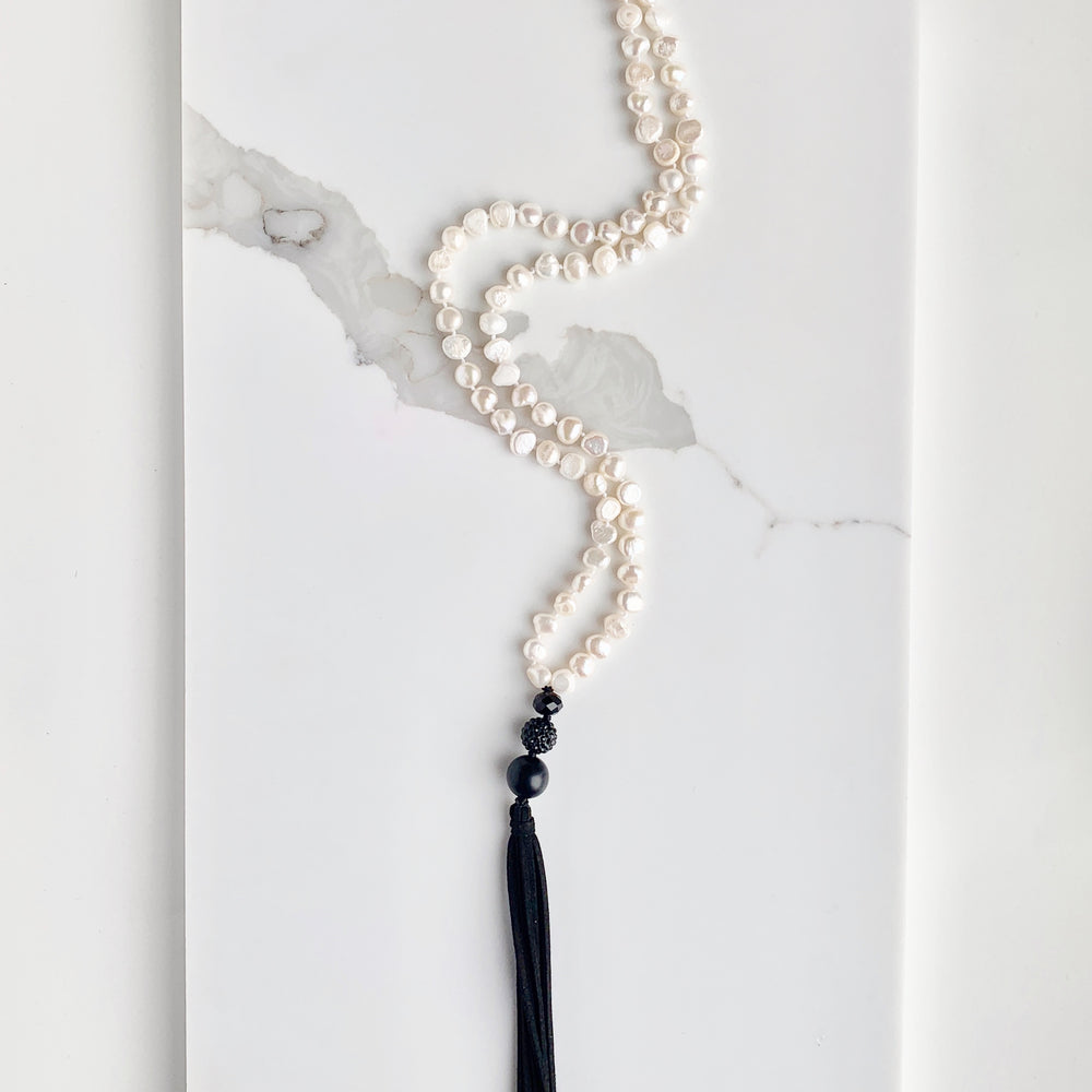 
                      
                        Freshwater Baroque White 8-9mm Pearls with Agate and Crystal and a Vegan Suede Tassel in Long 23” Necklace. Great on its own or Layered.
                      
                    