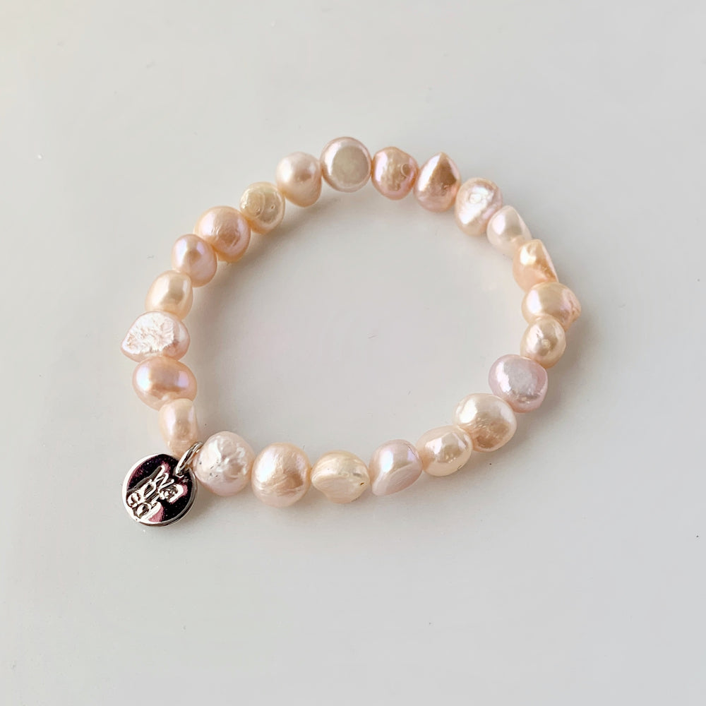 
                      
                        Pretty Stretch Bracelet with Baroque Pink/Peach Freshwater Pearls that can be Worn Alone or Stacked with your Other Favorites.
                      
                    