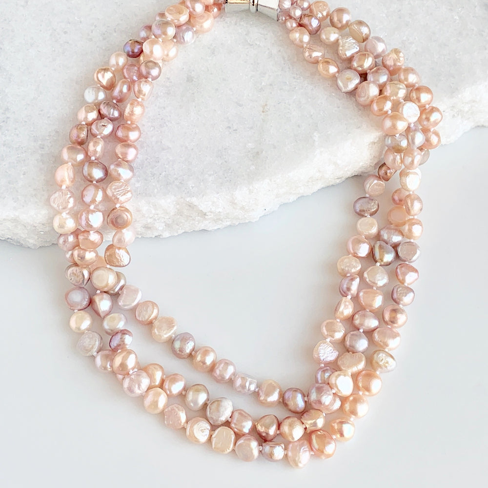 
                      
                        Three Strands of Knotted 8-9mm Pink Freshwater Baroque Pearls with a Strong Secure Magnetic Clasp for Easy Wear.
                      
                    