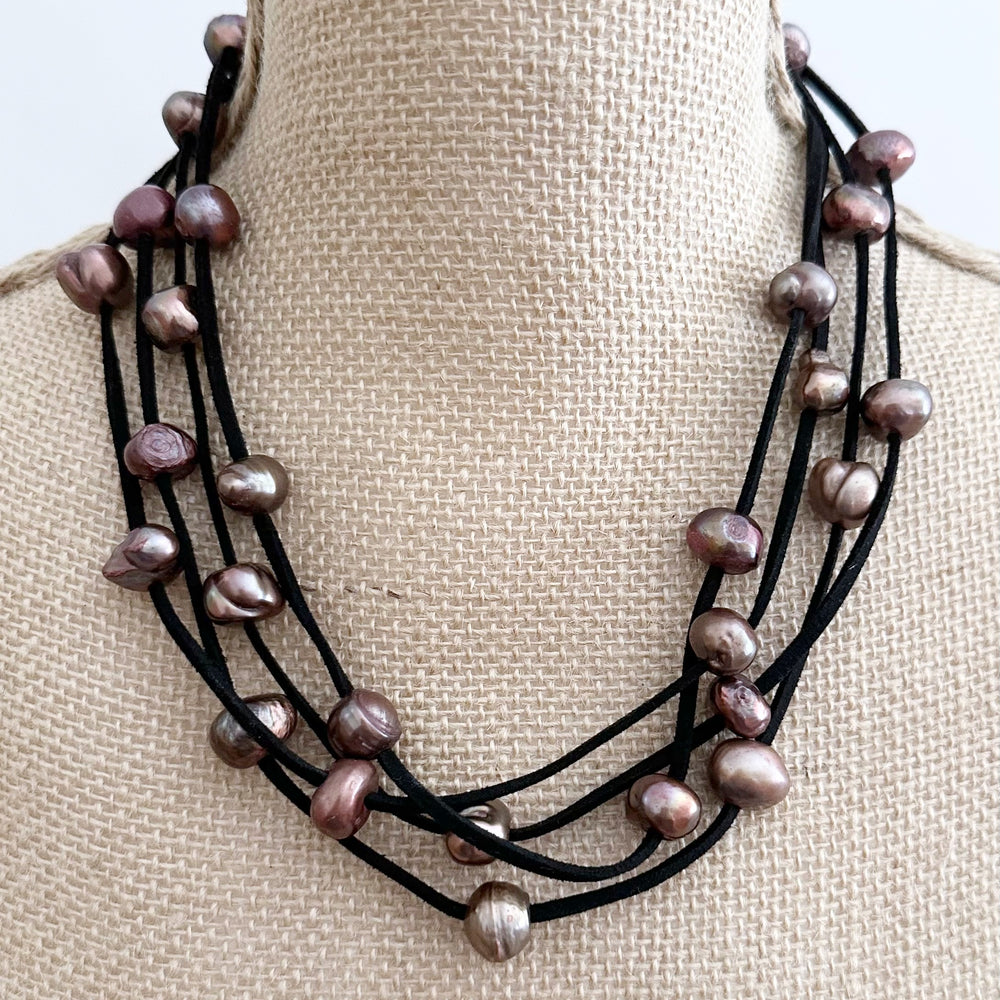 
                      
                        Large Baroque Freshwater Brown Pearls Floating on Two Strands of Black Vegan Suede for 40” Long Necklace Completed with Strong Secure Magnetic Clasp for Easy Wear.
                      
                    