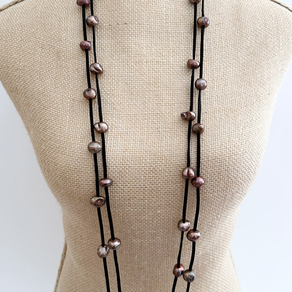 
                      
                        Large Baroque Freshwater Brown Pearls Floating on Two Strands of Black Vegan Suede for 40” Long Necklace Completed with Strong Secure Magnetic Clasp for Easy Wear.
                      
                    