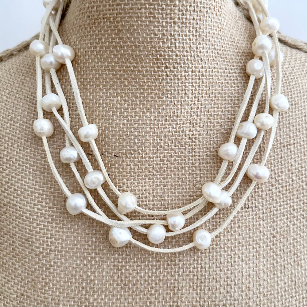 
                      
                        Large Baroque Freshwater White Pearls Floating on Two Strands of Cream Vegan Suede for 40” Long Necklace Completed with Strong Secure Magnetic Clasp for Easy Wear. Shown Doubled on Bust
                      
                    