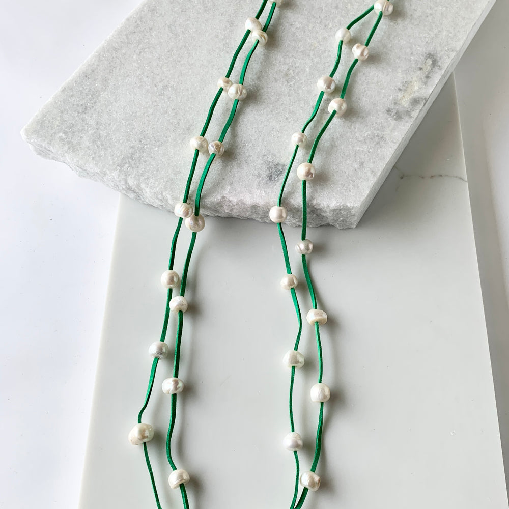 
                      
                        Large Baroque Freshwater White Pearls Floating on Two Strands of Kelly Green Vegan Suede for 40” Long Necklace Completed with Strong Secure Magnetic Clasp for Easy Wear.
                      
                    