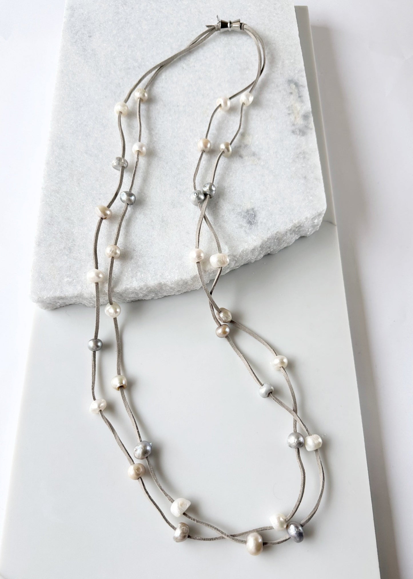 Large Baroque Freshwater Mixed-Color Pearls Floating on Two Strands of Light Grey Vegan Suede for 40” Long Necklace Completed with Strong Secure Magnetic Clasp for Easy Wear.