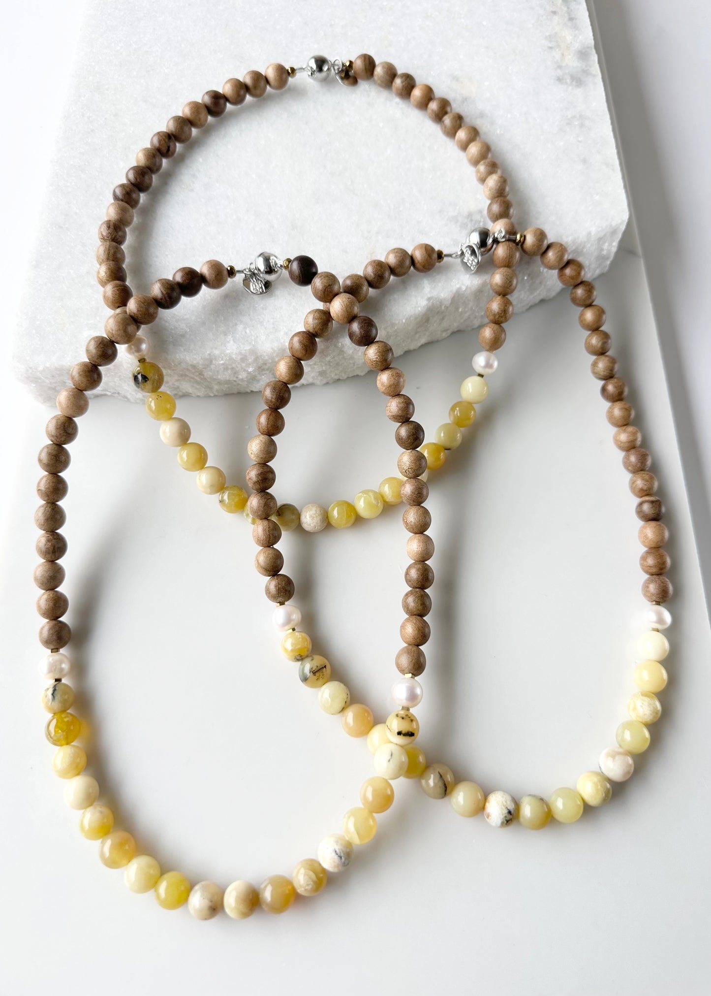 Designed and made in Canada, this Limited-Edition 20” Necklace Features Sunny Yellow Opal, Silkwood and Pearls Completed with Tiny Gold Accents and a Magnetic Clasp. This Gem brings an Elegant Touch of colour in a Lightweight Design that's Perfect for the Season.