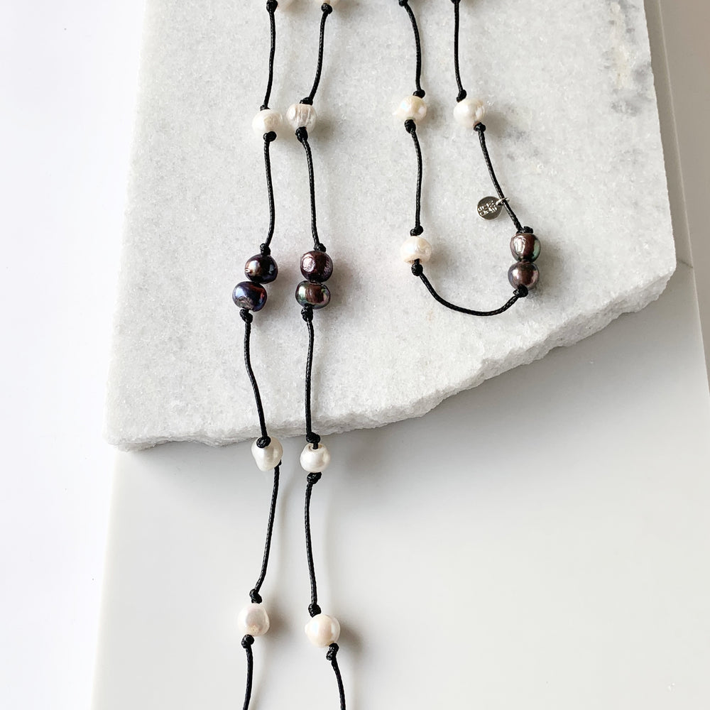 
                      
                        Freshwater Baroque Pearls Knotted on Black Cord in 24” Necklace that Can be Worn Long or Doubled.
                      
                    