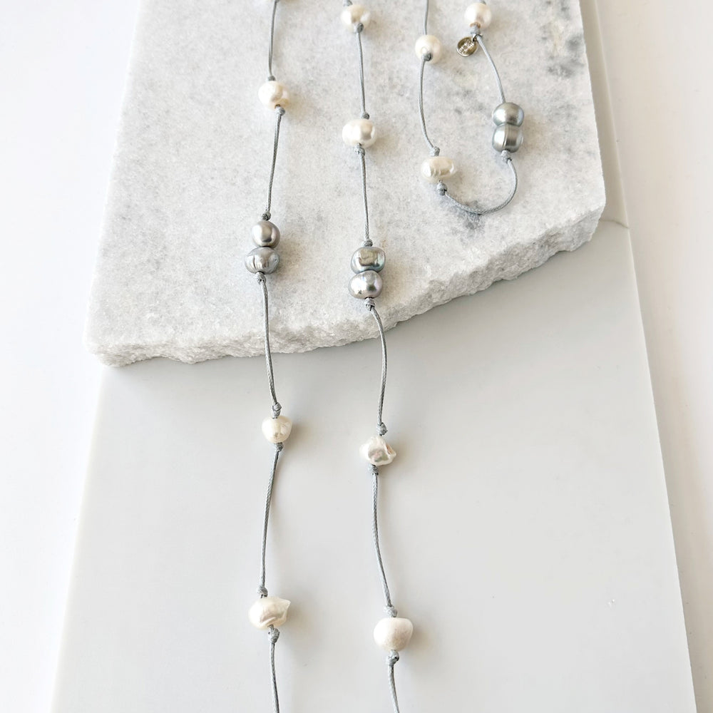 
                      
                        Freshwater Baroque Pearls Knotted on Grey Cord in 24” Necklace that Can be Worn Long or Doubled.
                      
                    