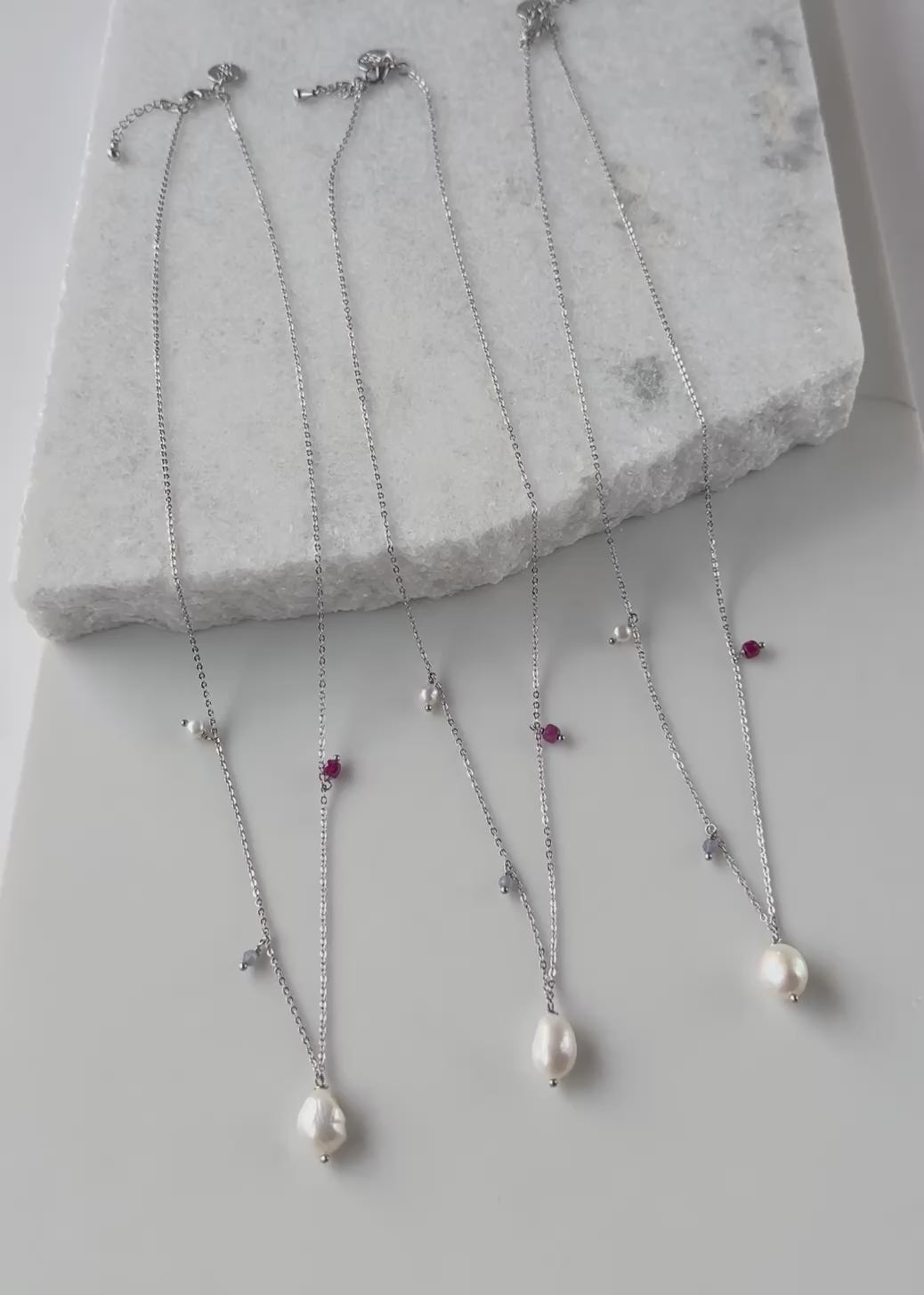 Designed and made in Canada, this 23.5” Necklace (plus 1.5” Extender) Combines Lustrous Freshwater Pearls with a Square Cut 4mm Ruby and Tiny Faceted 3mm Tanzanite, on Delicate Gold-Plated Chain for a Pretty Look.