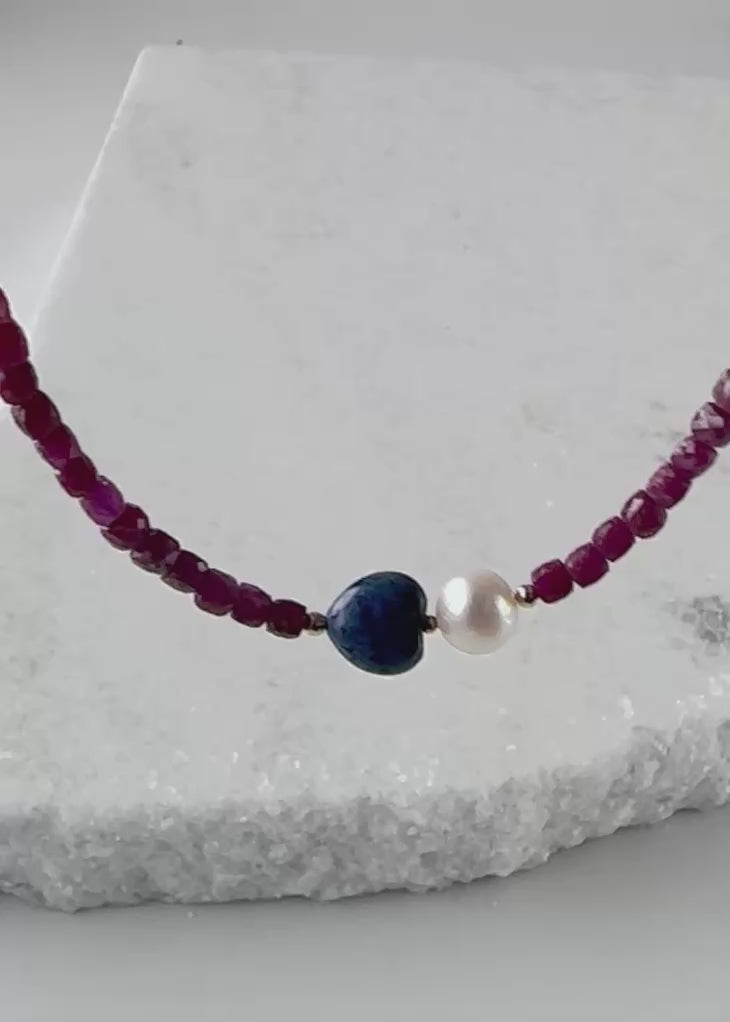Designed and made in Canada, this Delicate One-Of-A-Kind 18” Necklace features Gorgeous Faceted 4mm Ruby, a Blue 10mm Dumortierite Heart and White Pearls accented with Gold Beads and finished with a Gold-Filled Hook Clasp.