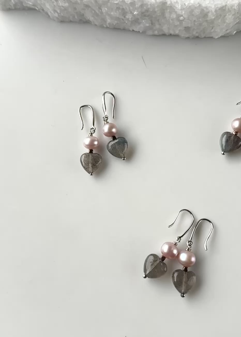 Designed and made in Canada, the Hope Earrings Feature Sweet Semi-Precious Stone Hearts with Lustrous Freshwater Pearls. The Length is 1 3/8" and they are Gold-Plated over Silver Fishhook.