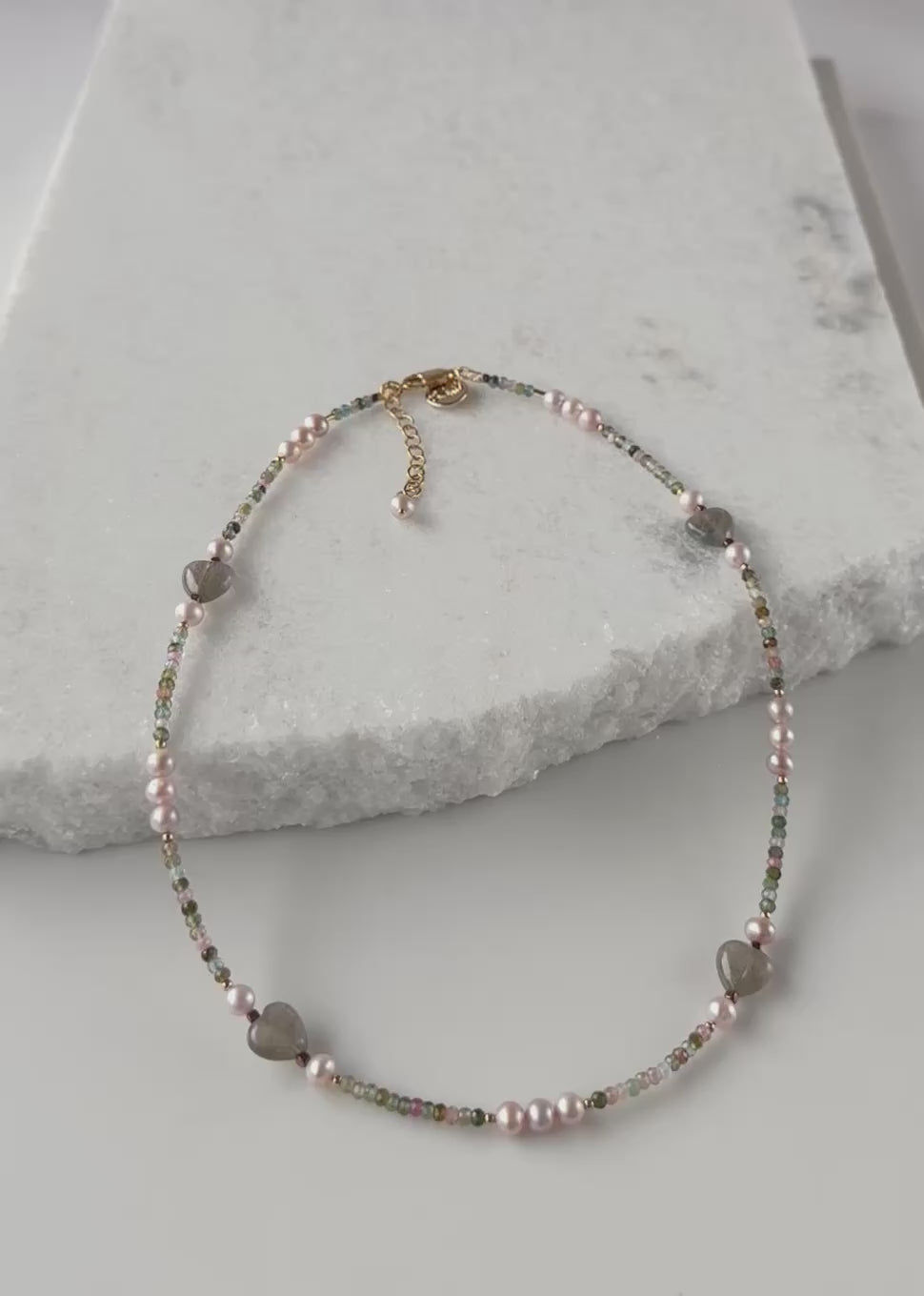 Designed and made in Canada, this Delicate, One-Of-A-Kind 17.5” Necklace Features Faceted 3mm Tourmaline, Charming Labradorite 10mm Hearts and Pretty Pink 5mm Pearls accented with Gold-Filled Beads and Completed with a Gold-Filled Lobster Claw Clasp.