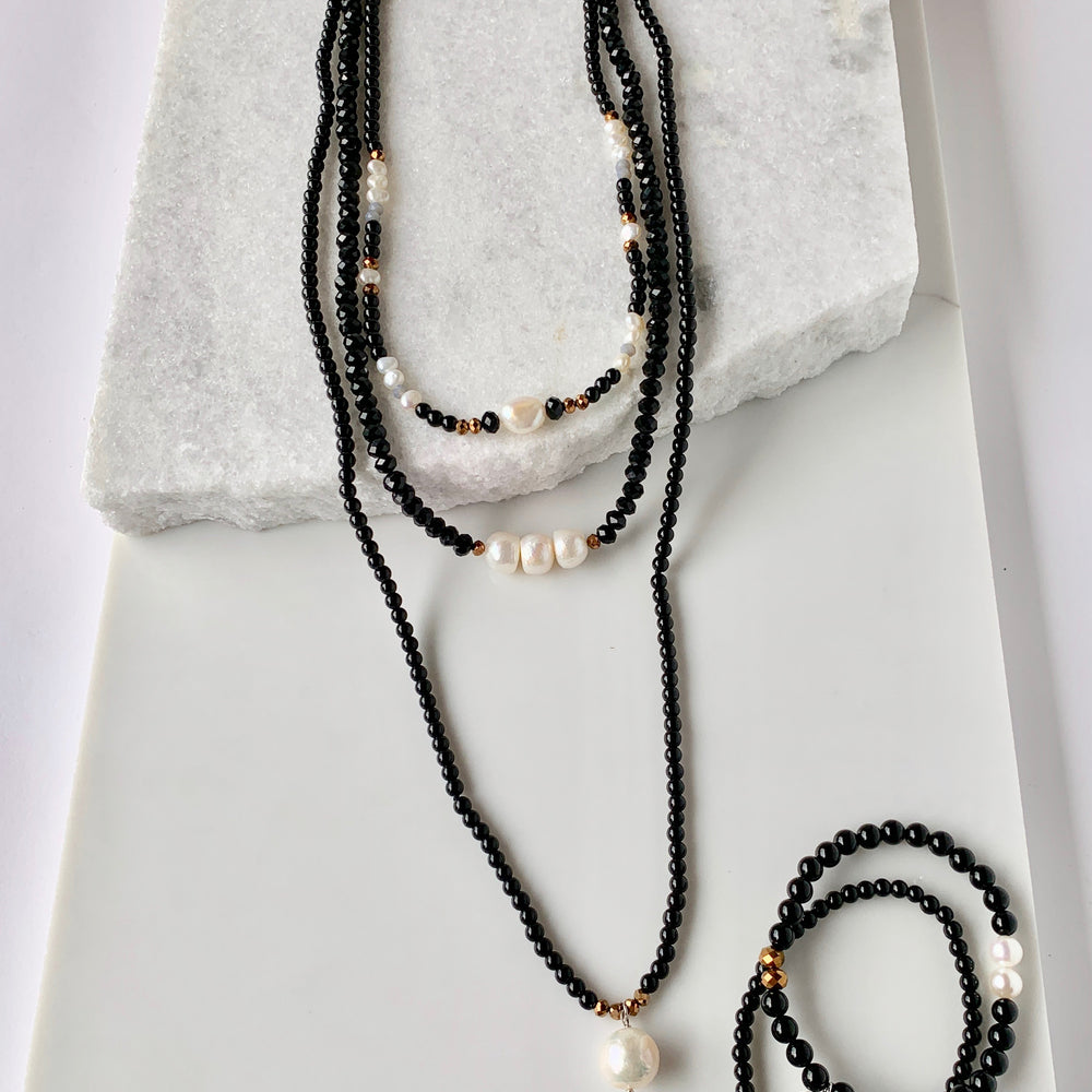 
                      
                        Necklace with White Freshwater Pearls, Faceted Black Crystal and Black Agate (Show with Complementary pieces for a fun, layered look)
                      
                    