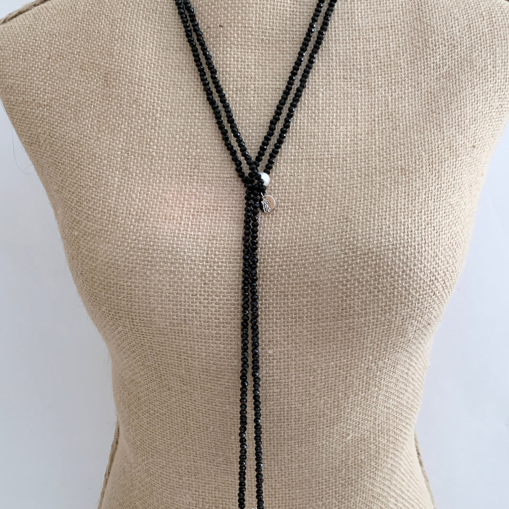 
                      
                        Long, 64-inch Lariat-Style Necklace with Black Crystals and White Freshwater Pearls.  This Versatile piece allows it to be worn in many ways. Shown on Bust
                      
                    