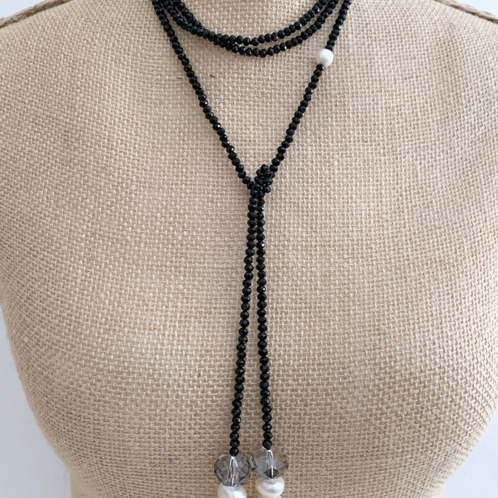 
                      
                        Long, 64-inch Lariat-Style Necklace with Black Crystals and White Freshwater Pearls.  This Versatile piece allows it to be worn in many ways. Shown on Bust in Different Style
                      
                    