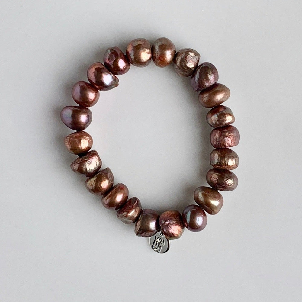 
                      
                        Large Baroque Brown Freshwater Pearls are designed in this Stretch Bracelet. This can be worn by itself or Stacked with others.
                      
                    