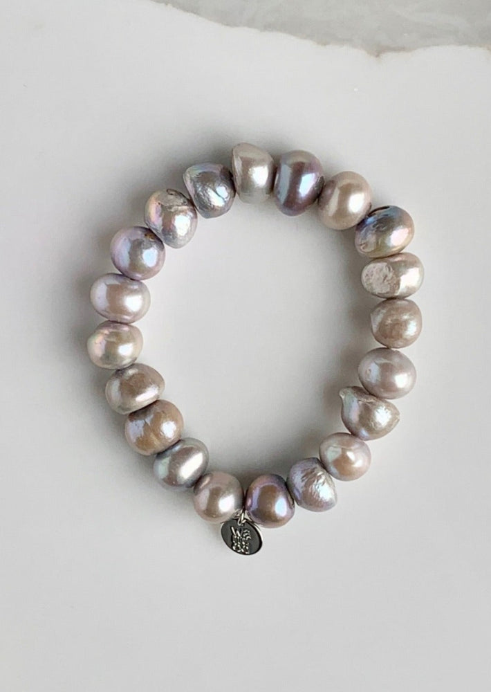 
                      
                        Large Baroque Silver Freshwater Pearls are designed in this Stretch Bracelet. This can be worn by itself or Stacked with others.
                      
                    