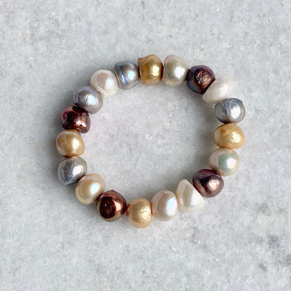 
                      
                        Large Baroque Colour Mix Freshwater Pearls are designed in this Stretch Bracelet. This can be worn by itself or Stacked with others.
                      
                    