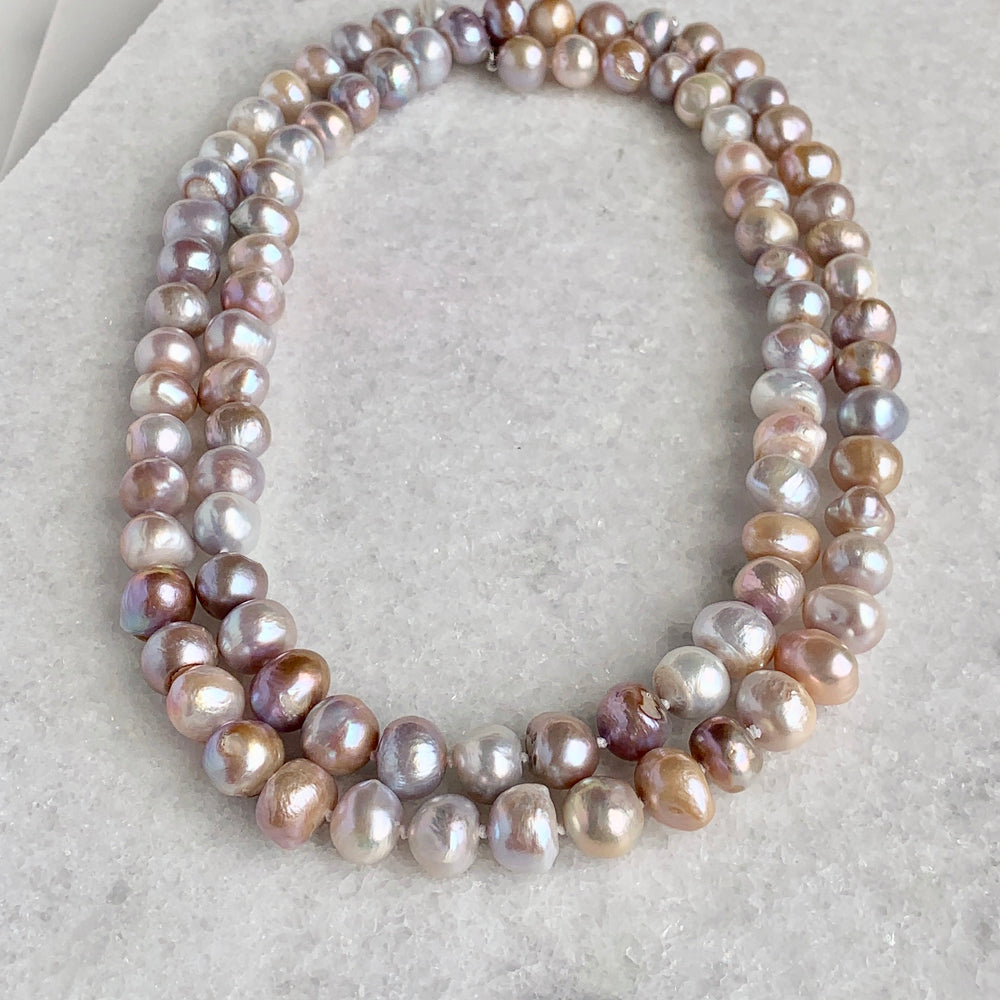 
                      
                        Large (12mm) Lustrous Natural Pink Freshwater Pearls Knotted on a Long (36”) Necklace that allows for Single or Doubling Up. It is Completed with a Lobster Claw Clasp for Easy, Reliable Wear. Doubled
                      
                    