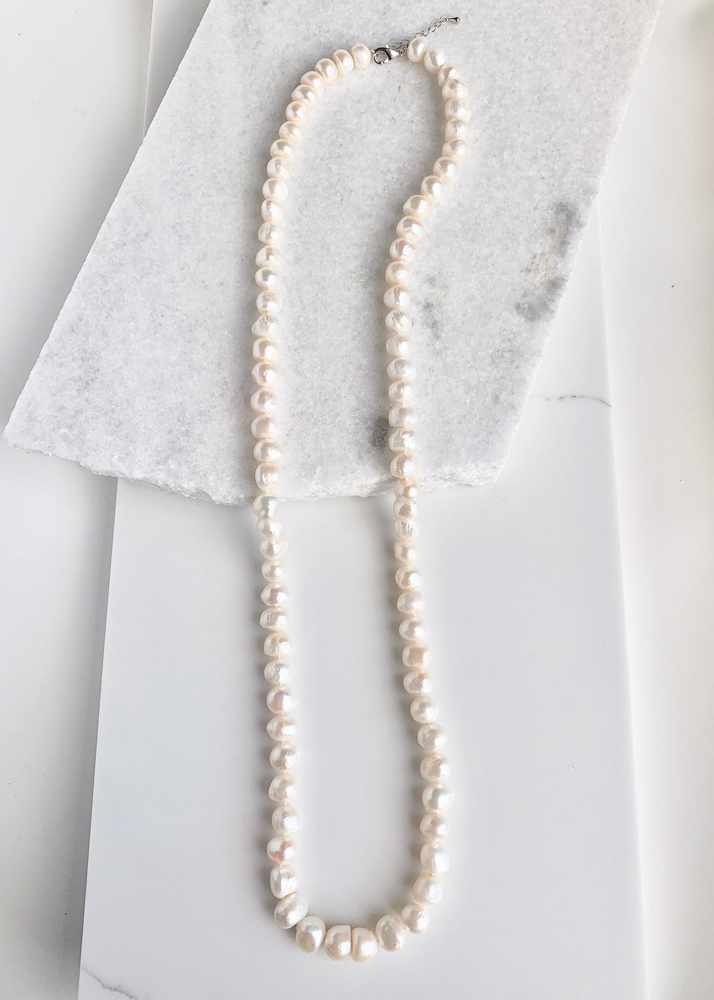 Large (12mm) Lustrous White Freshwater Pearls Knotted on a Long (36”) Necklace that allows for Single or Doubling Up. It is Completed with a Lobster Claw Clasp for Easy, Reliable Wear.