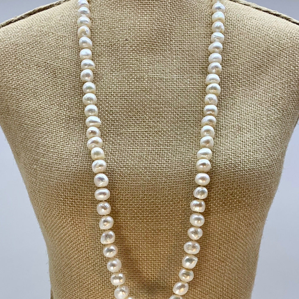
                      
                        Large (12mm) Lustrous White Freshwater Pearls Knotted on a Long (36”) Necklace that allows for Single or Doubling Up. It is Completed with a Lobster Claw Clasp for Easy, Reliable Wear. On Bust
                      
                    