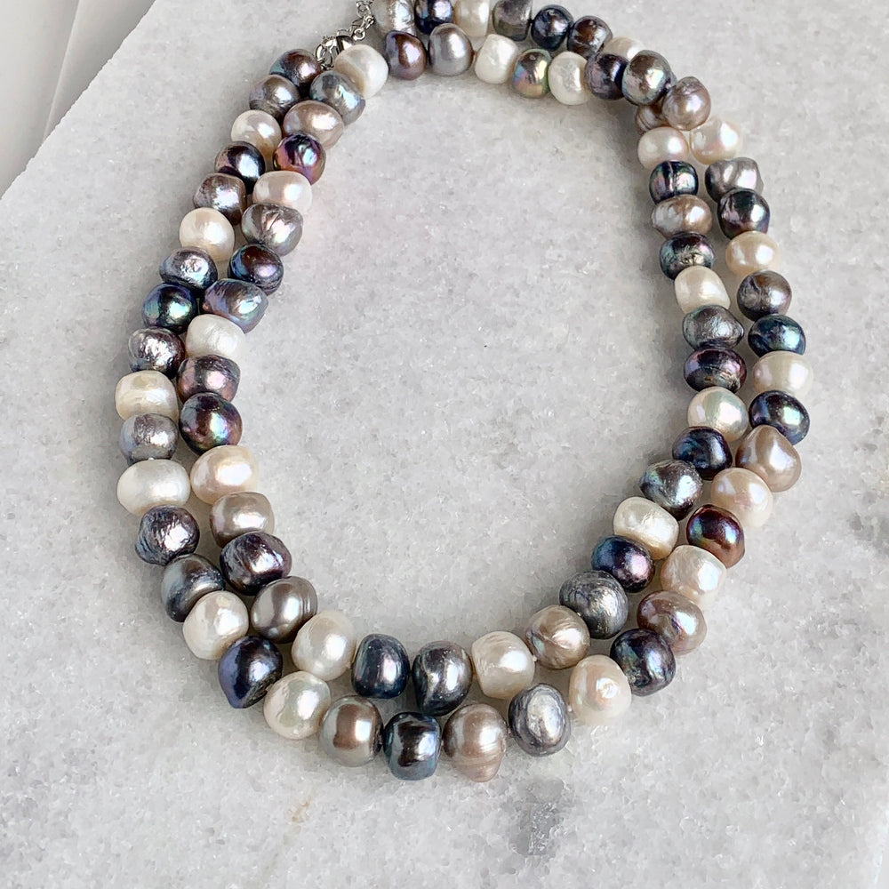 
                      
                        Large (12mm) Lustrous White Silver and Black Freshwater Pearls Knotted on a Long (36”) Necklace that allows for Single or Doubling Up. It is Completed with a Lobster Claw Clasp for Easy, Reliable Wear. Doubled
                      
                    
