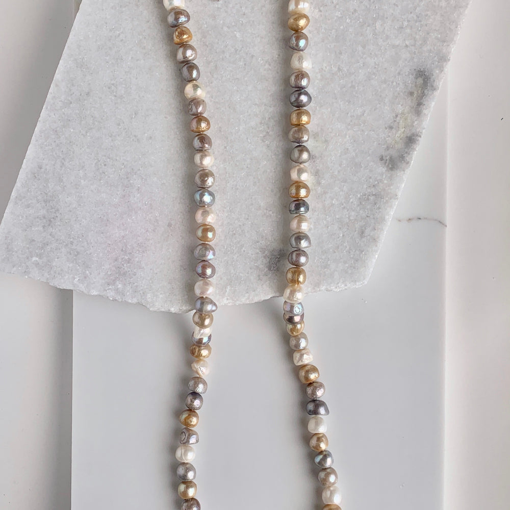 
                      
                        Large (12mm) Lustrous White Silver and Gold Freshwater Pearls Knotted on a Long (36”) Necklace that allows for Single or Doubling Up. It is Completed with a Lobster Claw Clasp for Easy, Reliable Wear.
                      
                    