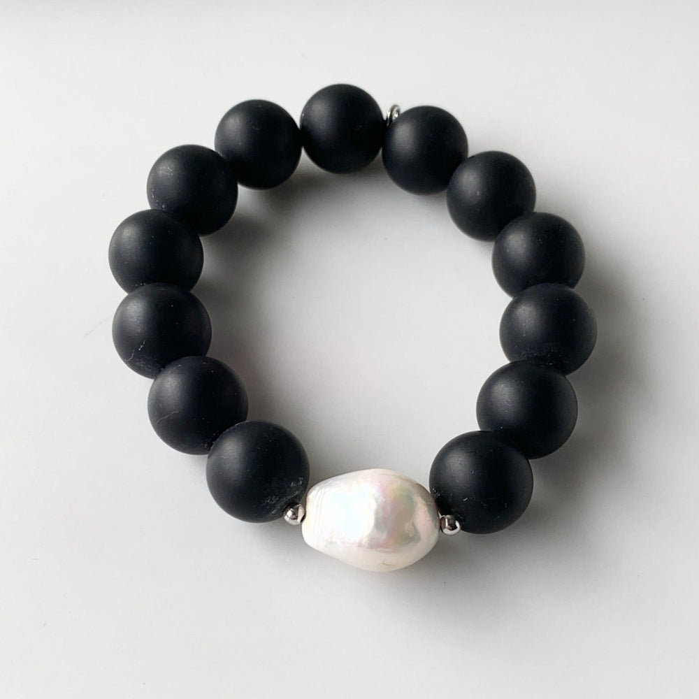 
                      
                        Stretch Bracelet Highlighting a Large White Baroque Freshwater Pearl with Silver Accents with Large (14mm) Matte Black Agate.
                      
                    