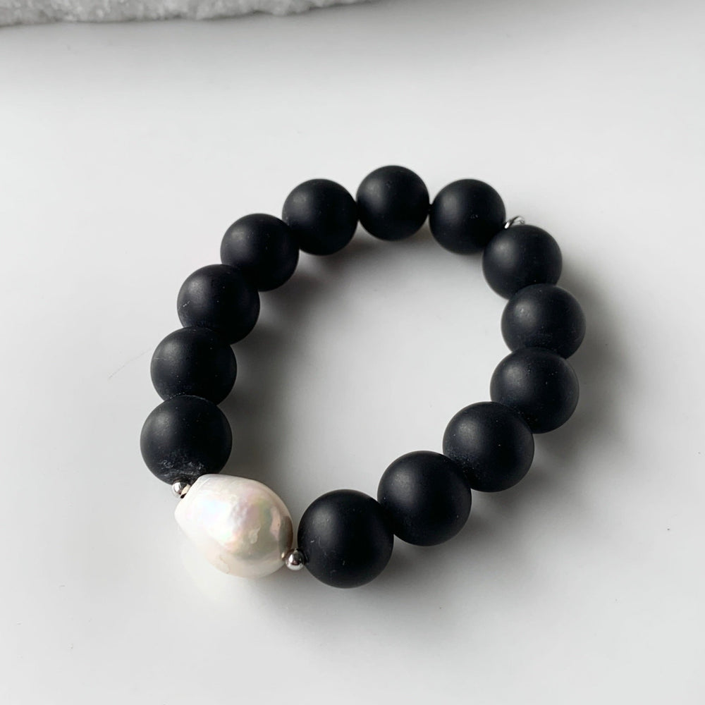 
                      
                        Stretch Bracelet Highlighting a Large White Baroque Freshwater Pearl with Silver Accents with Large (14mm) Matte Black Agate.
                      
                    