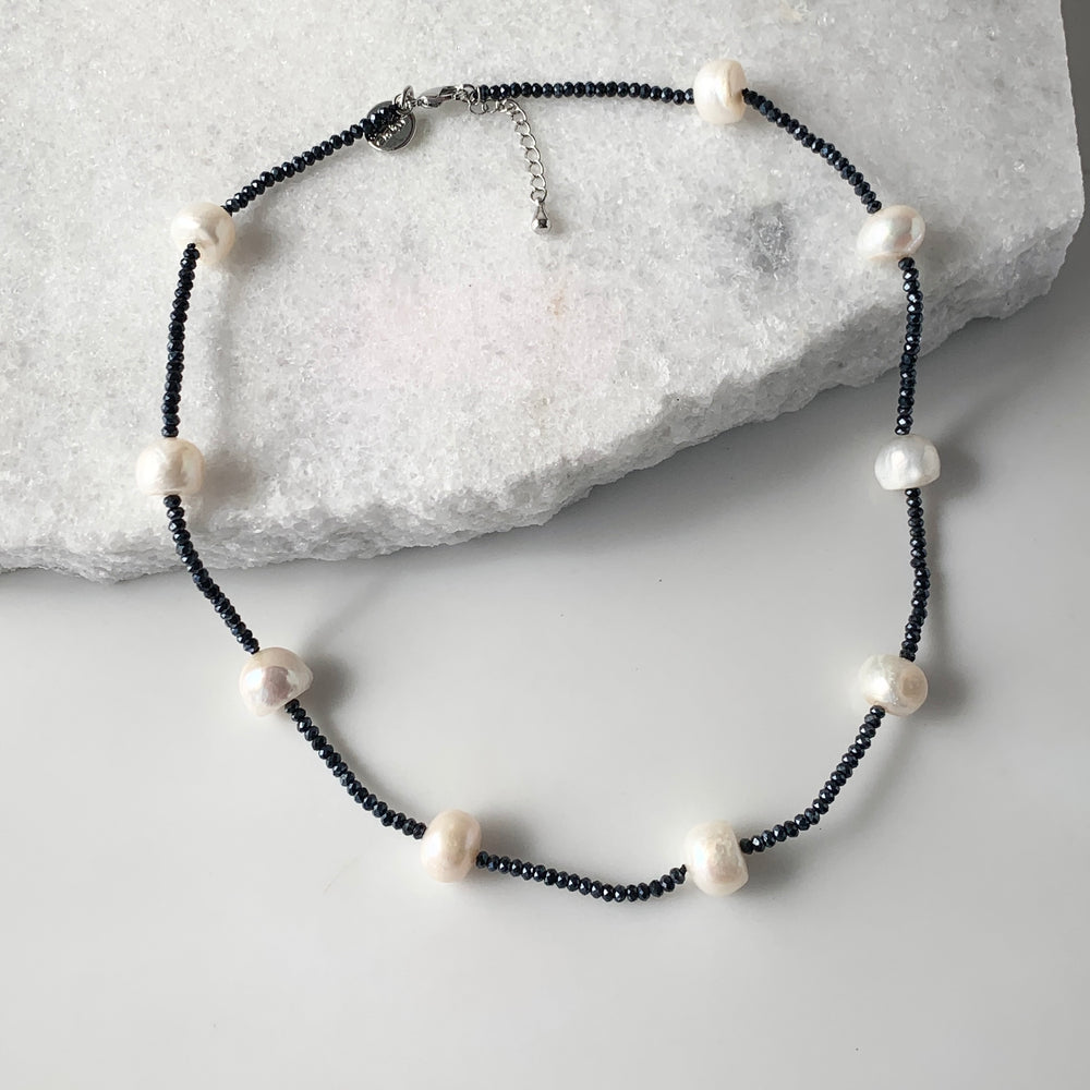 White Freshwater Pearls and Navy (2mm) Faceted Crystals form this 18” Necklace with 1.5” Extender.  The Piece is finished with a Lobster Claw Clasp.