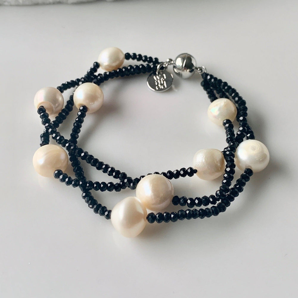 Three Strands of White Baroque Freshwater Pearls and 2mm Faceted Black Crystals on this Bracelet with Strong Secure Magnetic Clasp for Easy Wear.