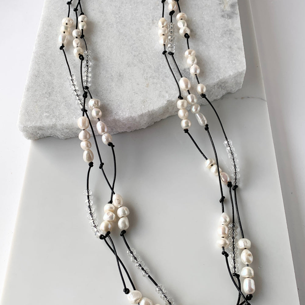 White Baroques Freshwater Pearls and White Faceted Crystals on Black Knotted Leather For a Long  39” Necklace with Strong Secure Magnetic Clasp for Easy Wear.