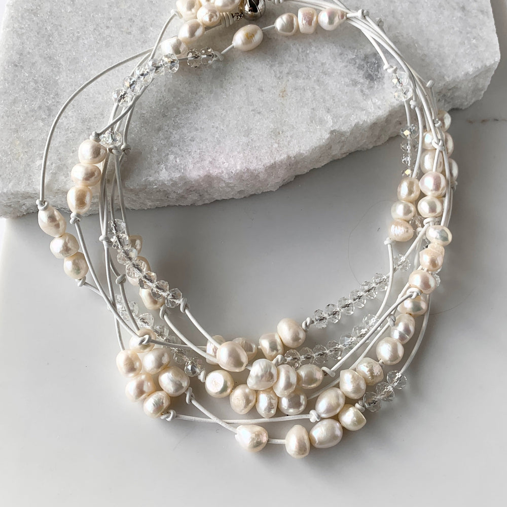 
                      
                        White Baroques Freshwater Pearls and White Faceted Crystals on White Knotted Leather For a Long  39” Necklace with Strong Secure Magnetic Clasp for Easy Wear.
                      
                    